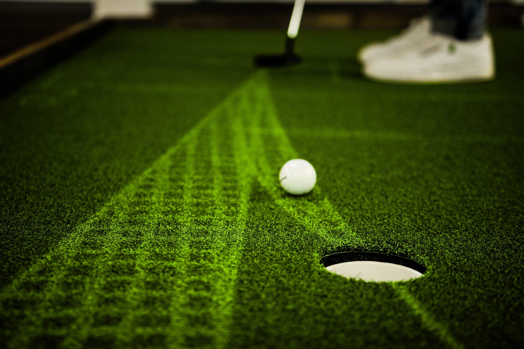 Golf ball on a putting green with projected line data